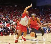  ?? DAVID JABLONSKI / STAFF ?? Zed Key, then playing for Ohio State, guards Dayton’s DaRon Holmes II during an exhibition last October at UD Arena. Key is now a Flyer.