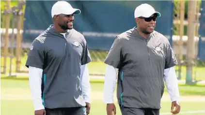  ?? JOE CAVARETTA/SOUTH FLORIDA SUN SENTINEL ?? Coach Brian Flores, left, and general manager Chris Grier have made the moves to put the Dolphins in position to get a franchise quarterbac­k.