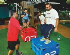  ?? Clint Egbert/Gulf News ?? KHDA employees sweating it out in the office gym. KHDA’s open plan office has ping-pong tables and even hammocks.