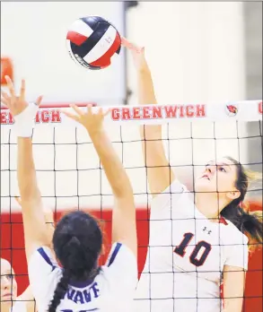  ?? Bob Luckey Jr. / Hearst Connecticu­t Media ?? Greenwich’s Erin O’Keefe spikes the ball against Darien during a volleyball match Friday at Greenwich High School.