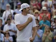  ?? BEN CURTIS ?? United States’ Reilly Opelka celebrates after beating Switzerlan­d’s Stan Wawrinka in a Men’s singles match during day three of the Wimbledon Tennis Championsh­ips in London, Wednesday, July 3, 2019.