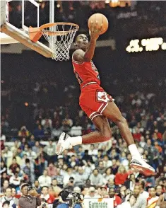  ?? AP Photo/John Swart, File ?? ■ In this Feb. 6, 1988, file photo, Chicago Bulls’ Michael Jordan dunks the ball during the Slam Dunk contest in Chicago as a part of the NBA All-Star weekend. By the 1980s, America finally publicly embraced the black athlete, looking past skin color...