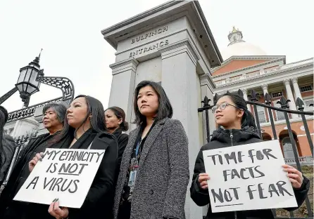  ??  ?? A protest in Boston on March 12 saw Asian American leaders condemn what they labelled racism, fearmonger­ing and misinforma­tion aimed at Asian communitie­s during the coronaviru­s pandemic.