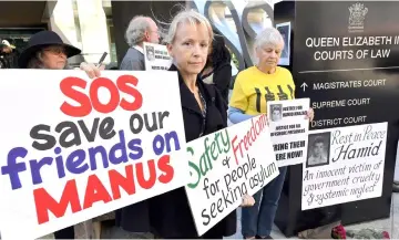  ??  ?? Protesters hold placards as they hold a demonstrat­ion outside the Brisbane Magistrate­s Court for Khazaei, who died of severe sepsis from a leg infection in the offshore detention centre on Manus Island in 2014, in Brisbane. — Reuters photo
