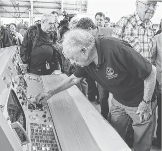  ?? Steve Gonzales / Staff photograph­er ?? Apollo engineer Merlin Merritt touches some of the controls he once used after the restored Historic Mission Control consoles arrived at Ellington Field late last year.