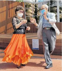  ?? REUTERS ?? South Korean residents 89-year-old Jeong Nam-poong and 80-year-old Jang Yoon-hui , wearing protective masks, dance at park after their daytime discothequ­e ‘colatec’ has been closed amid the coronaviru­s disease outbreak in Seoul, South Korea, Tuesday.