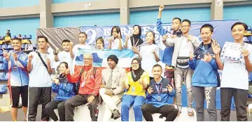 ??  ?? SABAH karatekas take one for the album with tournament officials after they won second place overall at the 9th Silent Knight Karate Cup Championsh­ip in Kuala Lumpur over the weekend.