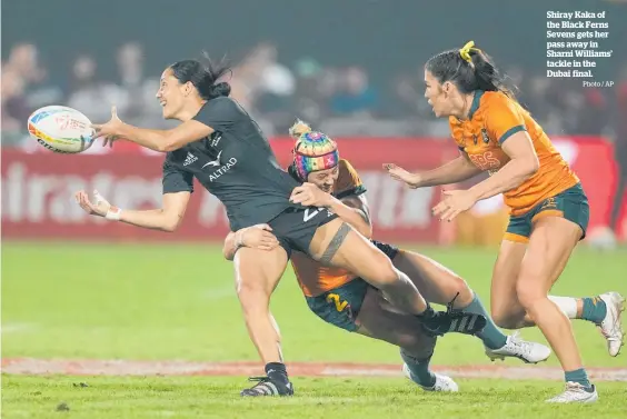  ?? Photo / AP ?? Shiray Kaka of the Black Ferns Sevens gets her pass away in Sharni Williams’ tackle in the Dubai final.