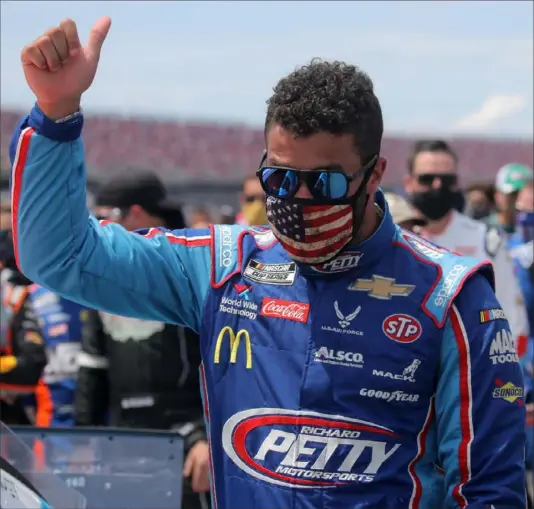  ?? Chris Graythen/Getty Images ?? Bubba Wallace, the only Black driver in the NASCAR Cup Series, gives a thumbs up before the Geico 500 Monday. A noose was found in Wallace’s garage stall a week after NASCAR banned the Confederat­e flag at its facilities.