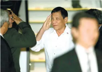  ?? (AP FOTO) ?? PRESIDENT RODRIGO DUTERTE (center) arrives at Haneda internatio­nal airport in Tokyo. Duterte is on a three-day official visit to Japan.