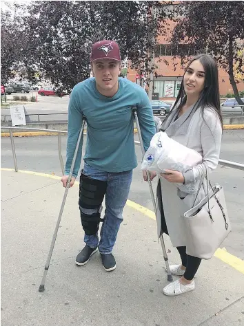  ??  ?? Paul Biegel of Dawson Creek, B.C. was one of four people hit Saturday night by a U-Haul truck fleeing police in downtown Edmonton. Biegel, shown with his girlfriend Tiana Clarke, says he feels lucky to be alive.