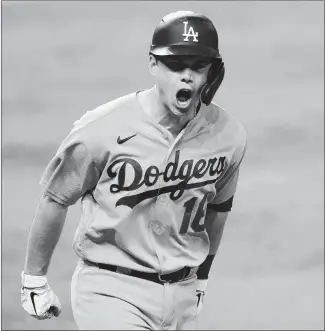  ?? TOM PENNINGTON/GETTY-AFP ?? The Dodgers’Will Smith celebrates his three-run homer against the Braves in Friday night’s Game 5.