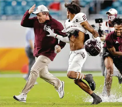  ?? Michael Reaves / Getty Images ?? Had a 12-team playoff been in place last season, coach Jimbo Fisher and Texas A&M likely would’ve hosted Indiana in the opening round as the No. 6 seed, according to an AP analysis. Instead, the Aggies were the last team out of the playoff.