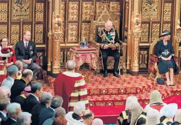  ?? ALASTAIR GRANT/GETTY-AFP ?? Sitting in for the queen: Britain’s Prince Charles, center, is flanked by Camilla, Duchess of Cornwall, and Prince William in the House of Lords during opening ceremonies for Parliament on Tuesday in London. Queen Elizabeth II, 96, missed the ceremonial opening for the first time while she prepares to celebrate 70 years on the throne.