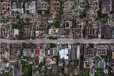  ?? (The New York Times/David Guttenfeld­er) ?? The ruins of buildings in Irpin, a suburb of Kyiv, Ukraine, are seen Monday after weeks of fierce fighting between Russian and Ukrainian forces. Targets in eastern and southern Ukraine were pummeled by Russian forces on Monday, continuing a two-week offensive.