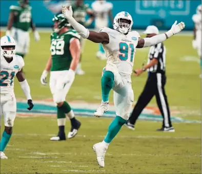  ?? Wilfredo Lee / Associated Press ?? Miami Dolphins defensive end Emmanuel Ogbah celebrates after sacking New York Jets quarterbac­k Joe Flacco during the second half on Sunday in Miami Gardens, Fla.