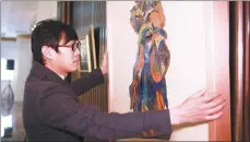  ??  ?? Shi Jun presents his artwork at the Peninsula Shanghai Hotel to celebrate the upcoming Spring Festival.