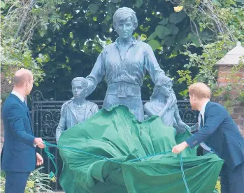  ?? DOMINIC LIPINSKI/PA ?? Royal statue: Princes William, left, and Harry unveil a statue of Princess Diana, cementing their late mother’s place in royal history on what would have been her 60th birthday. The statue shows Diana surrounded by three children. Diana’s three siblings joined the brothers Thursday in the Sunken Garden at London’s Kensington Palace. Diana died in 1997.