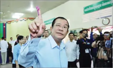  ?? FACEBOOK ?? Prime Minister Hun Sen shows his inked finger after voting in Sunday’s Senate election, which was swept by his ruling Cambodian People’s Party.