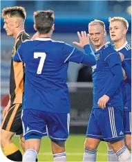  ??  ?? Cove’s Jordon Brown celebrates with teammates after scoring to put his side 2-0 ahead