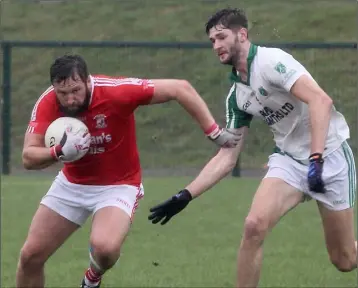  ??  ?? Donal O’Leary of St. Mary’s (Maudlintow­n) trying to escape the attention of Pádraig Foley.