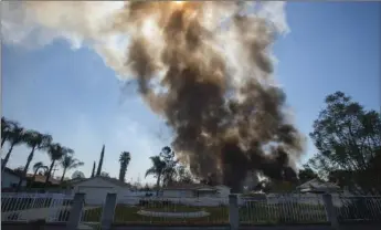  ?? WATCHARA PHOMICINDA/THE ORANGE COUNTY REGIS
TER VIA AP ?? In this Tuesday file photo, smoke rises in the background after a fireworks stash exploded in Ontario, Calif.