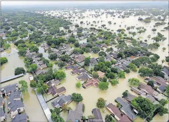  ?? [ASSOCIATED PRESS FILE PHOTO] ?? Some environmen­tal activists say Hurricanes Harvey and Irma should be a wake-up call that climate change is linked to the intensity and frequency of storms. Hurricane Harvey, shown here last month, devastated Houston.