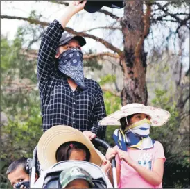  ?? NEW MEXICAN FILE PHOTO ?? Alexis Martinez Johnson protests in April outside the Roundhouse against Gov. Michelle Lujan Grisham’s shutdown. With Johnson are her four children: twins Vera and James, 2; Casandra, 7; and Conrad, 5.