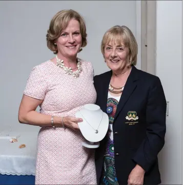  ??  ?? Nora Dodd, winner of the Lady President’s Prize competitio­n at Blainroe Golf Club, receives her prize from Lady President Bernie Nelson. Photos: Tim Thornton