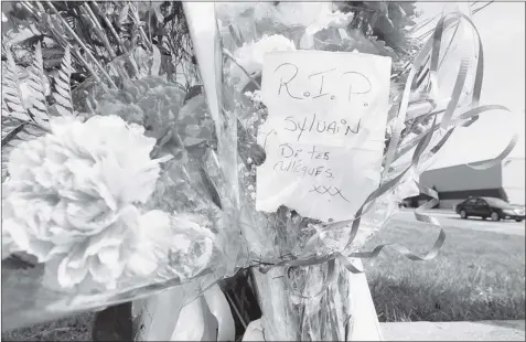  ?? JOHN MAHONEY/ THE GAZETTE ?? Flowers at the site honour STM bus driver Sylvain Ferland, who co-workers suggest might not have been wearing a seat belt in Tuesday’s crash.