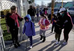  ?? MARCIO JOSE SANCHEZ / AP ?? Assistant Principal Janette Van Gelderen (left) welcomes students at Newhall Elementary School on Thursday in Santa Clarita, California. Elementary school students returned to school this week in the Newhall School District.