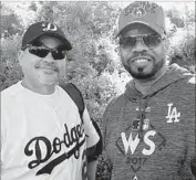  ?? Hailey Branson-Potts Los Angeles Times ?? ROBERT MEDINA, left, and Norman Davis attend Game 1 at Dodger Stadium. “I told my wife, ‘I want to do this before I die,’ ” said Medina, 39, of Bakersfiel­d.