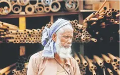  ??  ?? A labourer stands in front of a steel pipe storage rack at an industrial area in Mumbai, India. Last month, New Delhi sought an exemption from the new US tariffs, saying its steel and aluminium exports were small in relation to other suppliers. —...