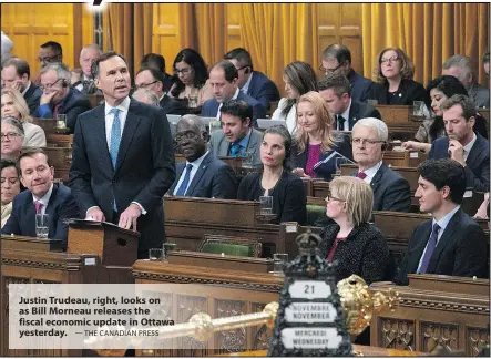  ?? — THE CANADIAN PRESS ?? Justin Trudeau, right, looks on as Bill Morneau releases the fiscal economic update in Ottawa yesterday.