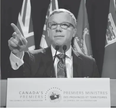  ?? PATRICK DOYLE / THE CANADIAN PRESS ?? Saskatchew­an premier Brad Wall speaks Friday before the first ministers meeting in Ottawa. Wall says the national climate plan will hammer Saskatchew­an jobs and industry. “We’re not signing.”