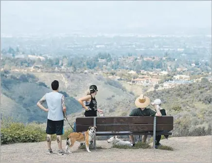  ?? Photograph­s by Myung J. Chun Los Angeles Times ?? MULHOLLAND DRIVE offers spectacula­r views of the San Fernando Valley. Caballero Canyon Trail, which starts off near 4030 Reseda Blvd., is one way to get there. The map, below left, can help you navigate, but beware — there are mountain lions in the area.