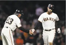  ?? Marcio Jose Sanchez / Associated Press ?? Mac Williamson gets a hand from third-base coach Ron Wotus while rounding the bases on his sixth-inning homer.