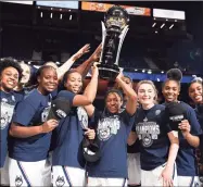  ?? Jessica Hill / Associated Press ?? UConn holds up the American Athletic Conference championsh­ip trophy after beating Cincinnati to win the league championsh­ip at Mohegan Sun Arena in March. With UConn back in the conference, the Big East announced Tuesday that it will hold its league tournament at Mohegan Sun.