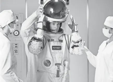  ?? DIYAH PERA/ NETFLIX ?? Emma Green ( Hilary Swank) suits up for a mission to Mars in Netflix’s “Away.”