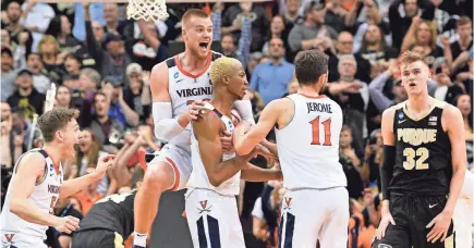  ?? JAMIE RHODES/USA TODAY SPORTS ?? Virginia forward Mamadi Diakite is surrounded by teammates, some now gone from the program, after his tying shot against Purdue in the Elite Eight of the 2019 NCAA tournament.