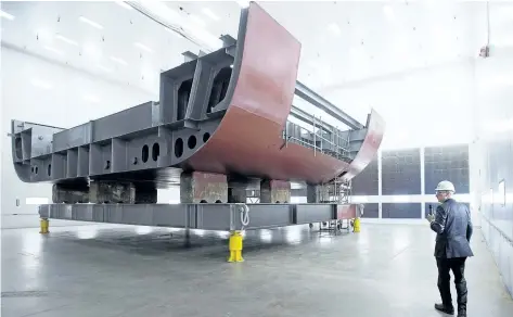  ?? ANDREW VAUGHAN/THE CANADIAN PRESS ?? Kevin McCoy, president of Irving Shipbuildi­ng, leads a tour as workers construct components of the Arctic offshore patrol ships at their facility in Halifax in 2016.