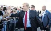  ?? PHOTO: REUTERS ?? Jubilant . . . An upbeat US President Donald Trump greets supporters at Palm Beach Internatio­nal Airport, as he arrives to spend Easter weekend at his MaraLago club in Florida yesterday.