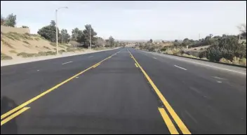  ?? PHOTO COURTESY OF CITY OF PALMDALE ?? Work is nearly complete on Segments 2 and 3 of the Pearblosso­m Highway Rebuild Project. The traffic lanes are freshly paved and striped, with some work expected to continue into the first few weeks of 2021.