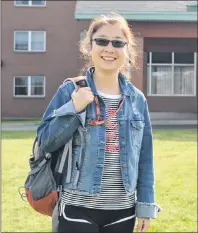  ?? NIKKI SULLIVAN/CAPE BRETON POST ?? Xin Li, a Chinese national taking the pre-MBA course at ICEAP, stands outside her residence on the CBU campus. Li and two of her classmates were told to speak English and go back to China by a young man outside of the Irving gas station on George...