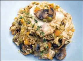  ?? ELIZABETH KARMEL — THE ASSOCIATED PRESS ?? This photo shows an under pressure quickie chicken and rice in New York. Whether you make the Spanish staple, Arroz con Pollo or make up your own version, it is soul-satisfying and perfect for the cooler weather.