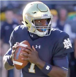  ?? (Photo by Charles Rex Arbogast, AP file) ?? Notre Dame quarterbac­k Brandon Wimbush rolls out to pass during a game earlier this season.