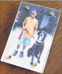  ??  ?? Leon, at about age 6, with Vicki’s dog Lucky, who died a couple of years ago at age 16.