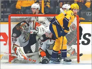  ?? BRUCE BENNETT / AFP ?? Anaheim Ducks goalie John Gibson and teammate Corey Perry get tangled in the net as Filip Forsberg of the Nashville Predators looks on during Game 4 of the Stanley Cup Western Conference finals at Bridgeston­e Arena, Nashville, on Thursday. The Ducks...