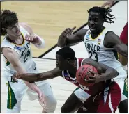  ?? (AP/Darron Cummings) ?? Arkansas guard Davonte Davis tries to get past Baylor’s Matthew Mayer (left) and Jonathan Tchamwa Tchatchoua on Monday night during the second half of the Razorbacks’ season-ending NCAA Tournament loss in Indianapol­is.