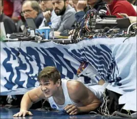  ?? MATT FREED — POST-GAZETTE VIA AP ?? Duke’s Grayson Allen ends up under the media row after diving for a loose ball against Rhode Island in the first half of the second-round game of the NCAA tournament March 17 in Pittsburgh.